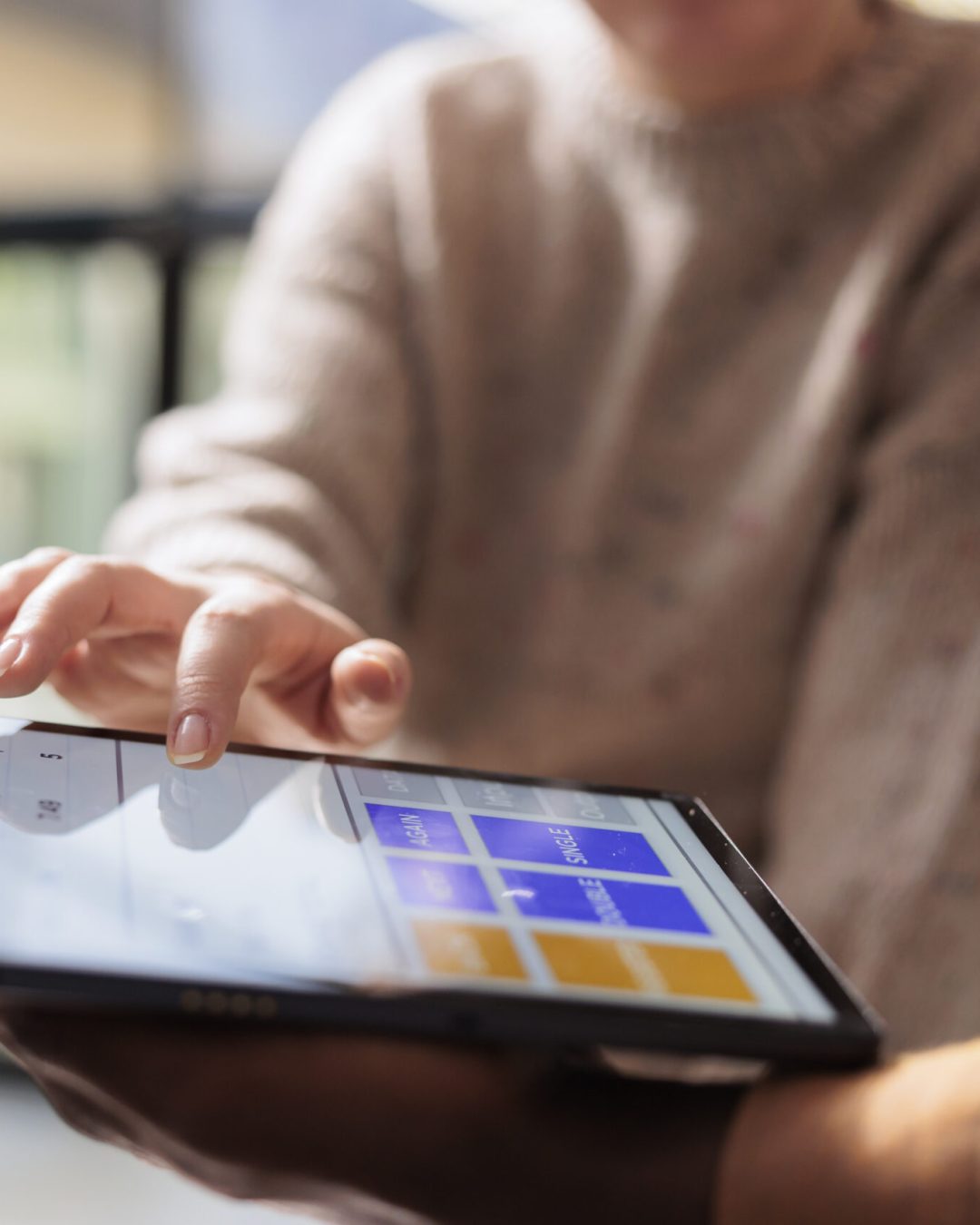 Diverse team analyzing goods quality control report on tablet computer, working at customers orders in storehouse. Stockroom employee preparing packages for delivery, checking clients detalis